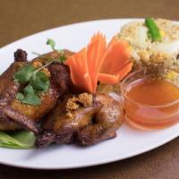 Bbq. Chicken With Curry Fried Rice · BBQ chicken marinated in coconut milk and Thai spices then served with curry rice.