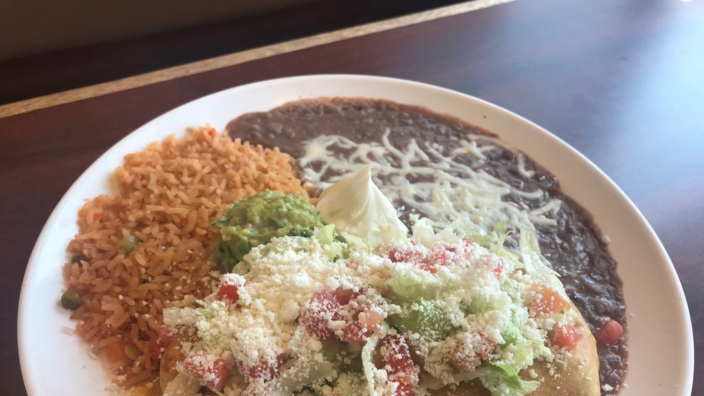 Chimichanga · Fried burrito stuffed with beans and your choice of meat. Served with rice, beans, sour cream, guacamole, lettuce, tomatoes, and Cotija cheese.