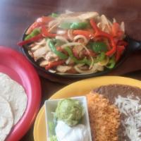 Chicken Fajitas · 10 oz chicken stripes red & green peppers onions Tomato cheese served with rice beans guacam...