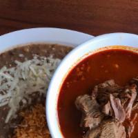 Birria De Res · A traditional stewed spicy beef. Served with rice, beans, and tortillas.