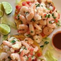 Tostadas De Ceviche · Small shrimps cooked in lemon with cucumbers, onions, tomatoes, and cilantro. Served on a ha...