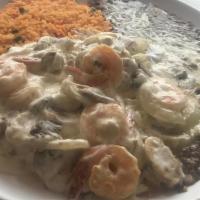 Camarones A La Crema · 9 shrimp cooked with sour cream sauce with onions, mushrooms, and cheese. Served with rice, ...