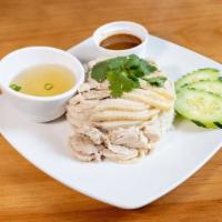 Hainan Chicken Rice · Poached chicken over seasoned rice with a side of garlic ginger sauce and a side of chicken ...