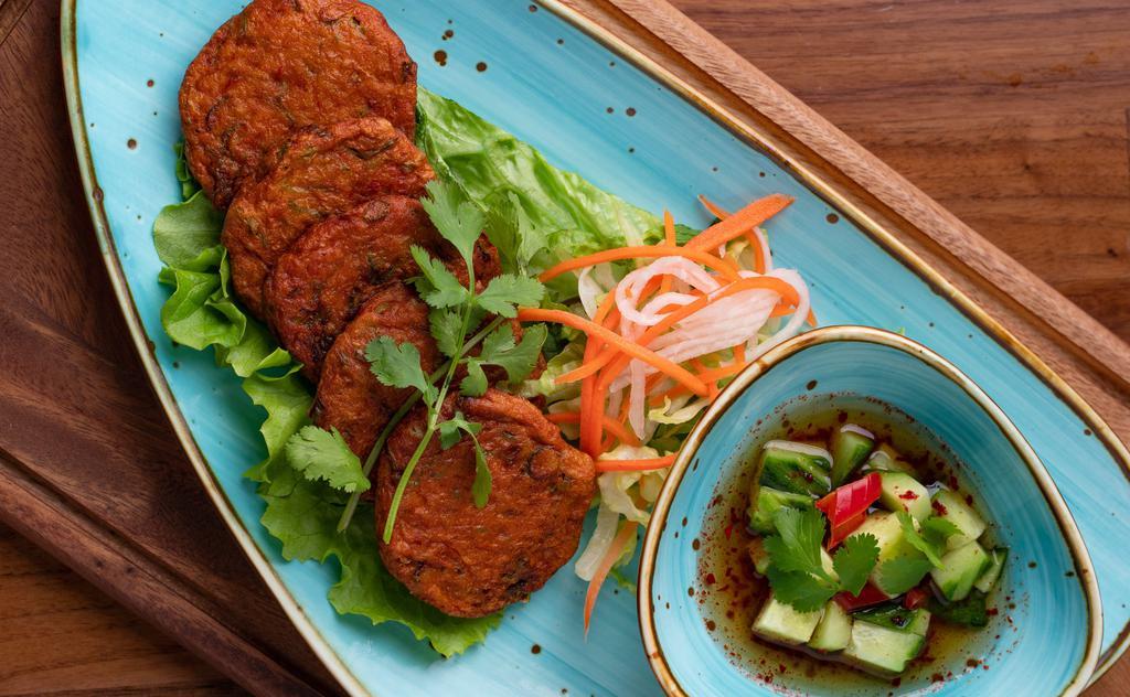 Fish Cake  · Gluten free. The fresh taste of the fish with spices, garlic, coriander ground and red chili. Served with cucumber salad and plum sauce.