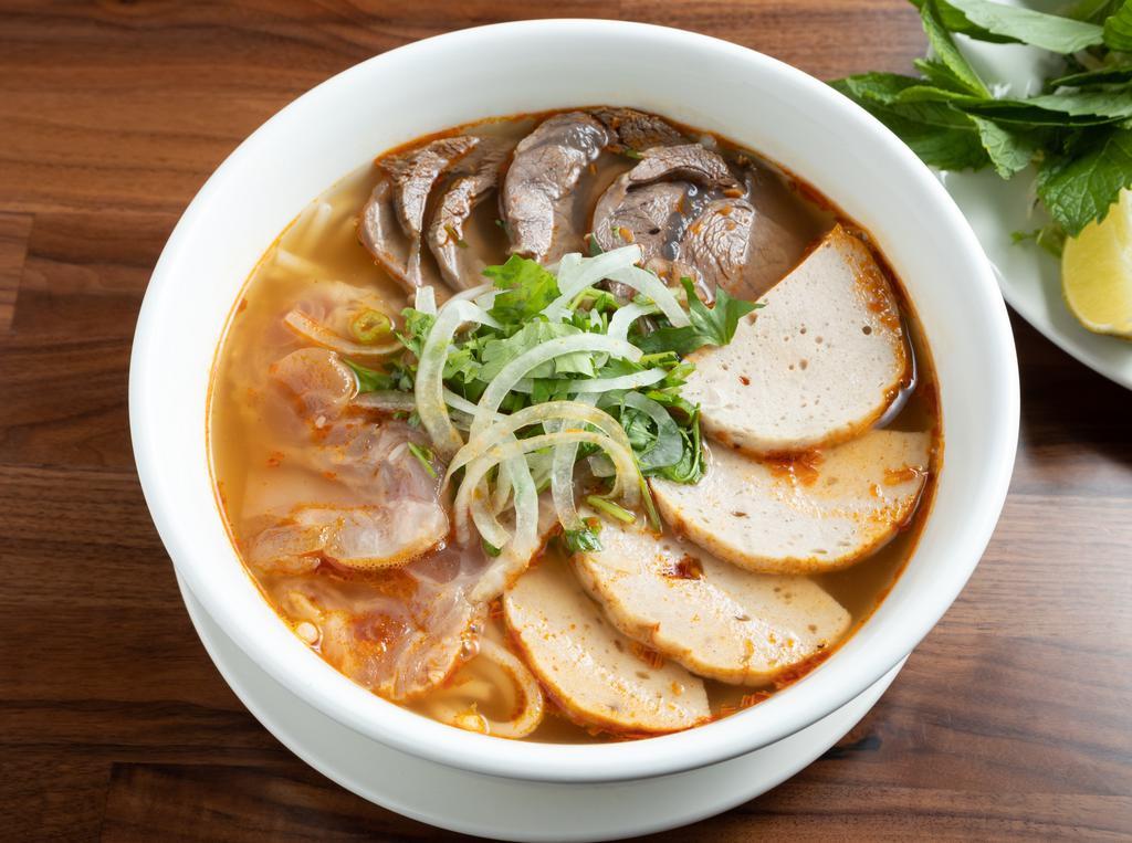 Hue Spicy Noodle Soup · Spicy and richly flavored beef soup with rice noodles, beef shank, beef tendon, and Vietnamese ham.