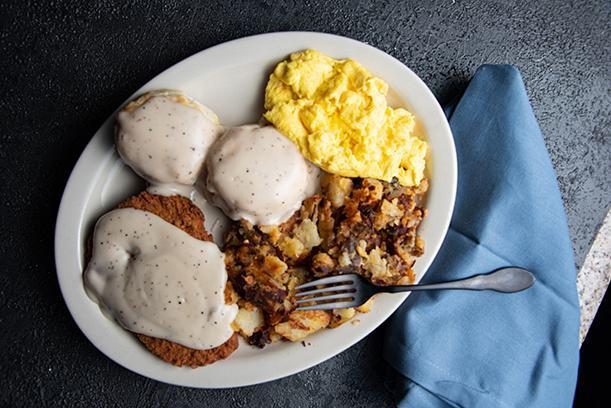 Country Breakfast · Chicken fried steak, two (2) biscuits topped with country gravy, and two scrambled eggs. Served with home fries