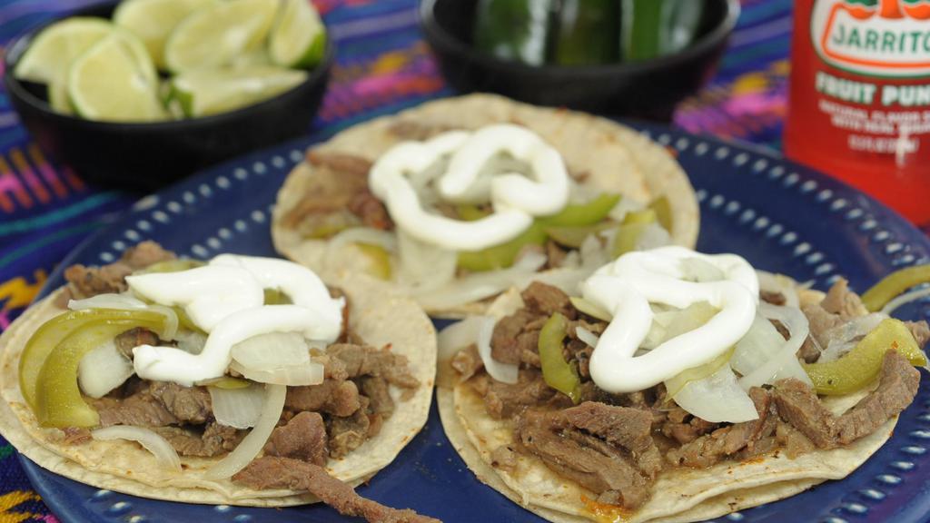 Steak Fajitas Taco · Asada steak, grilled bell peppers and onions, topped with sour cream