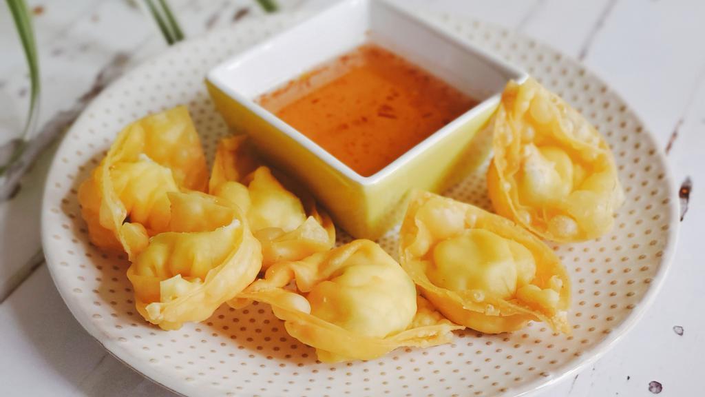 Crab Cheese Wonton · Crispy homemade wonton wrapped with cream cheese and imitation crab.  Served with homemade sweet and sour sauce.
