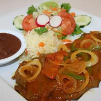 Skirt Steak (Bistec Encebollado) · cooked to perfection with grilled tomatoes, green peppers, and onions to give it a unique an...
