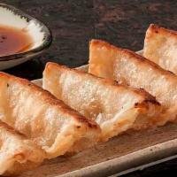 Gyoza · Eight Japanese dumplings filled with chicken and vegetables served either fried or steamed w...
