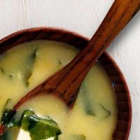 Miso Soup · A traditional savory soybean based soup with diced tofu, green onions, and wakame seaweed.