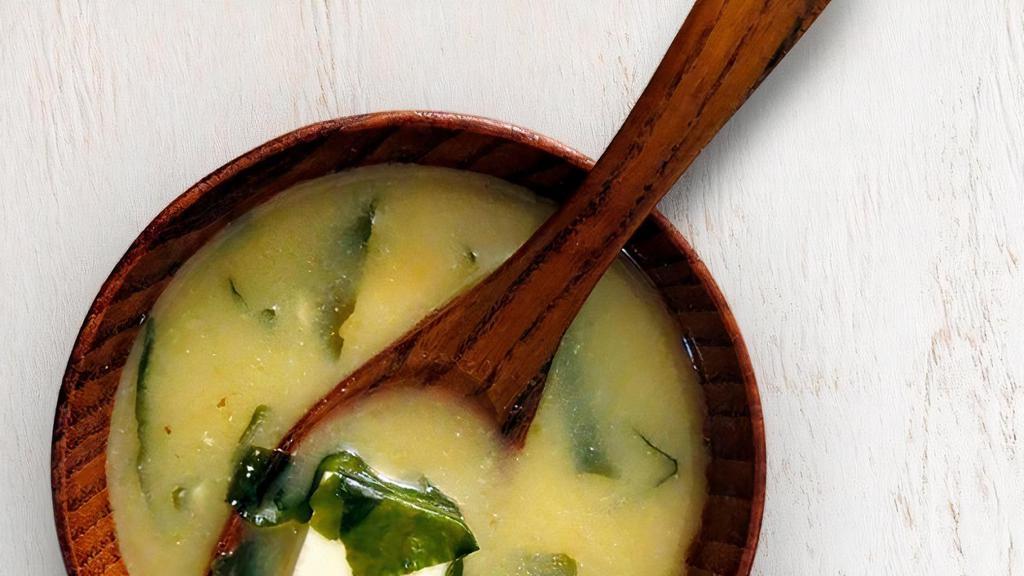 Miso Soup · A traditional savory soybean based soup with diced tofu, green onions, and wakame seaweed.