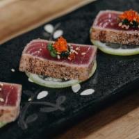 Blackened Tuna App · Six lightly seared black pepper coated tuna drizzled with a delicious citrus ponzu sauce.

C...