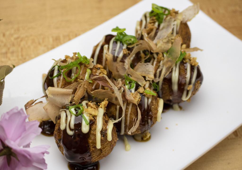 Takoyaki · 6 pieces of fried octopus balls. Come with Japanese mayo, crispy fried onion, bonito flakes, and green onion.