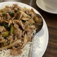 Mongolian Beef · Tender sliced beef sauteed with onion in a spicy garlic sauce served over crispy rice vermic...