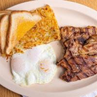 Pork Chop Breakfast · Two pieces of six ounce center cut pork chops, two eggs any style, hash browns, and toast.