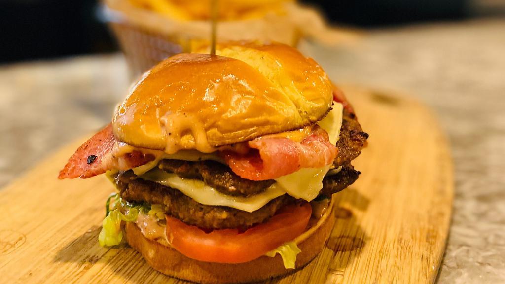 Classic (Double Patty On Photo Shown) · American cheese, smoked bacon, house spread, lettuce and tomato.