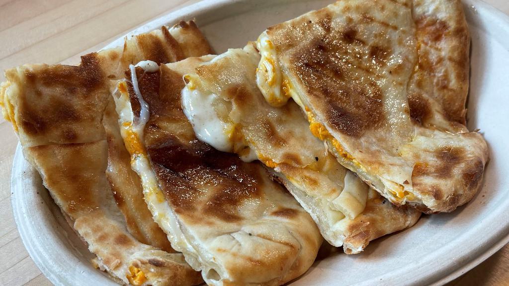 Naan Quesadilla · Fresh mozzarella and hand-roll naan bread with choice of protein.   Served with Tikka Dipping Sauce.