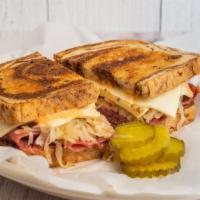 Reuben On Rye · Corned beef on rye bread with sauerkraut and Swiss cheese with garlic sauce, kosher pickle, ...