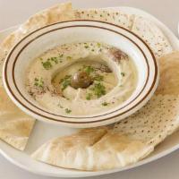 Hummus · A dip of chickpeas, tahini, lemon juice & garlic topped with olives oil. Served w/ fresh pita.