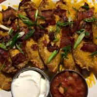 Tater Skins · Potato skins topped with Cheddar, bacon, green onion and a side of sour cream. Additional side
