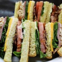 Everybody'S Club · Slow roasted turkey, thick grilled bacon, black forest ham, cheddar cheese, lettuce, and tom...