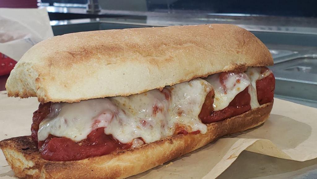 Meatball Sub · This is a great meatball sub. Lots of meatballs (all beef) in marinara.  We add three cheeses.  Parmesan, mozzarella and provolone.  Melted in our extra hot ovens.  For a great hot meatball sub.  New York style.