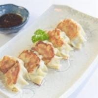 House Made Gyoza · Pan fried pork and cabbage pot stickers.
