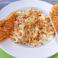Chicken Fettuccine · Fettuccine pasta and grilled chicken tossed in homemade alfredo sauce. Served with a slice o...