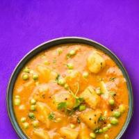  Potato In Peas (Vegan) · Potato and peas cooked together with onion, tomato and tossed with spices.