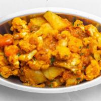 Aloo Gobhi (V) · Vegan. Cauliflower cooked with potato, ginger, garlic, tomato and spices.
