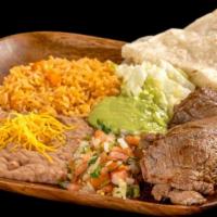 Carne Asada Plate · Grilled steak topped with pico de gallo, guacamole, and lettuce. Comes with one flour tortil...