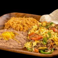 Machaca · Egg, shredded beef, onion, bell pepper, tomato, refried beans, and cheese.