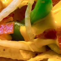 Super Cheesy Bacon Nachos · cheese, onions, bell peppers and bacon