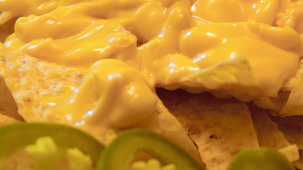 Cheesy Nachos · Classic styled nachos with cheese and jalapenos.