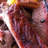 Pit Boss Special · 1/4 Pound of Hand Pulled Pork, 1/4 Pound of Sliced Prime Brisket, and a Rib with your choice...