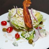 Wedge Salad · iceberg, crumbled gorgonzola, bacon, tomatoes, cucumber, olives, red onion, gorgonzola vinai...