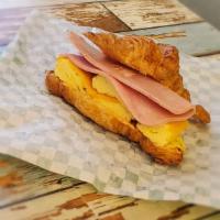 Egg, Ham & Cheese Croissant Sandwich · Homemade croissant with chipotle mayo, egg, ham and cheddar cheese, along with a hashbrown.