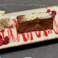White Chocolate Bread Pudding · white chocolate & raspberry sauces, fresh raspberries, whipped cream