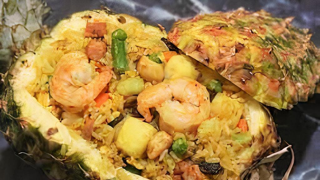 Pineapple Fried Rice · Fried rice with pineapple chunk, raisin, tomato, pea, carrot, onion, cashew nut, egg, shrimp and chicken.