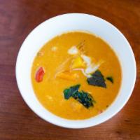 Pumpkin Red Curry · Fresh pumpkin chunk in a classic red curry, red bell pepper, and basil.