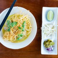 Khao Soi · Chicken and egg noodle in a Northern style curry soup topped with crispy egg noodles, served...