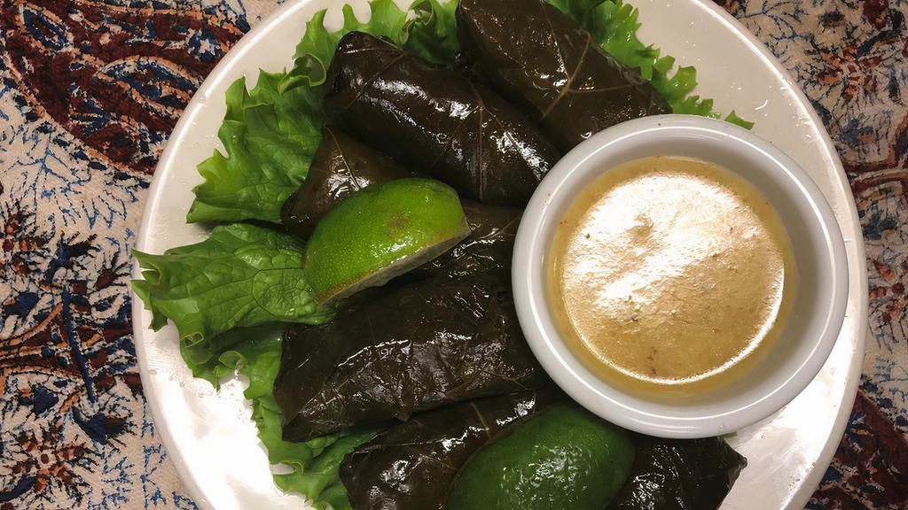Dolmas · Stuffed grape leaves with rice and herbs. Served chilled.