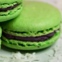 New Flavor:  Ube Macaron · Bold, purple ube buttercream inside a bright green shell.