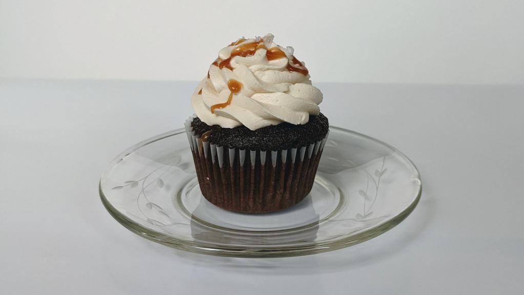 Caramel Filled Chocolate Cupcake · A chocolate cupcake filled with salted caramel, topped with caramel buttercream, a caramel drizzle, and flaky salt