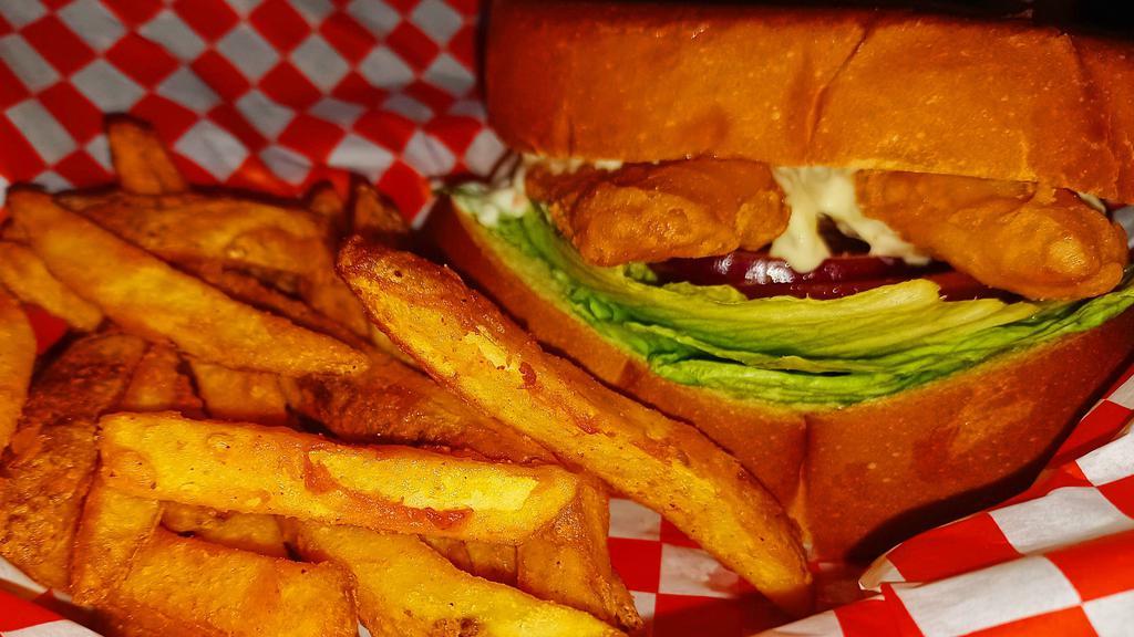Fish Filet Burger Combo · Large cuts of fried white fish on thick Texas toasted bread layered with tartar sauce, lettuce, tomato and pickles served with your choice of regular seasoned fries, curly fries or tater tots