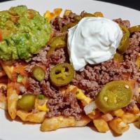 Loaded Fries With Beef Or Chicken · Large plate of golden fries layered with nacho cheese, topped with ground beef or chicken wi...