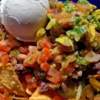 Loaded Nachos With Beef Or Chicken · Large order of crisp tortilla chips smothered in nacho cheese with ground beef or flame gril...