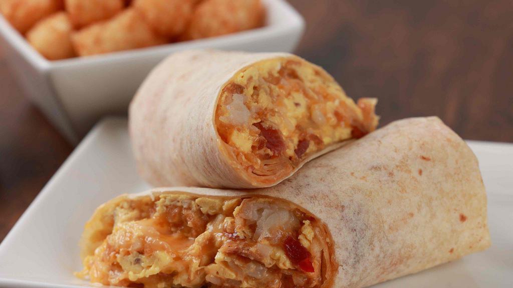 The Special K · Eggs, crispy bacon, mixed cheese, tater tots, caramelized onions and secret spicy sauce rolled into a warm flour tortilla.