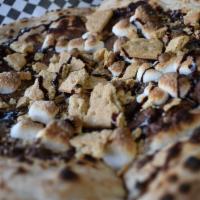 Md S’More Dessert Pizza · Hand stretched dough topped with nutella, graham cracker crumb, roasted marshmallows, and a ...